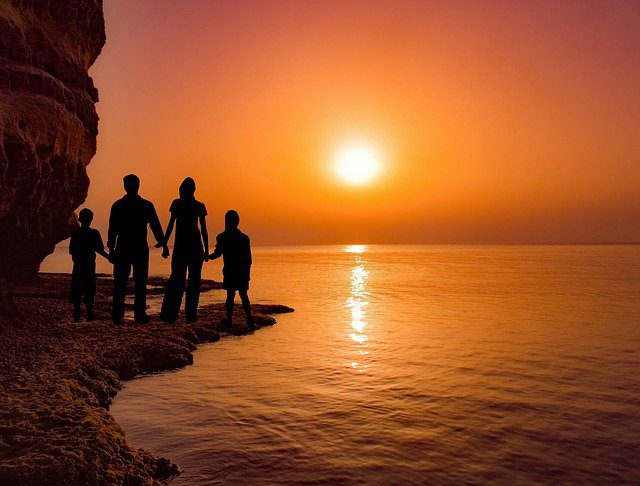 family vacation on the beach at sunset