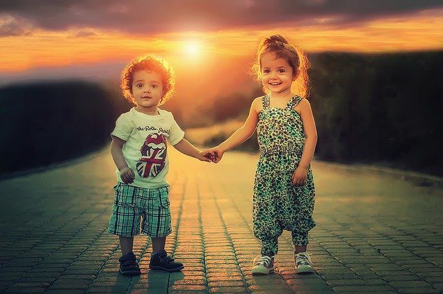 children in front of sunset