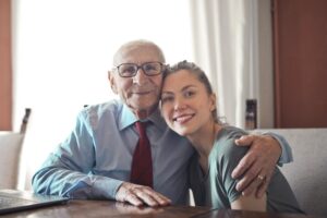 elderly man hugging a young lady